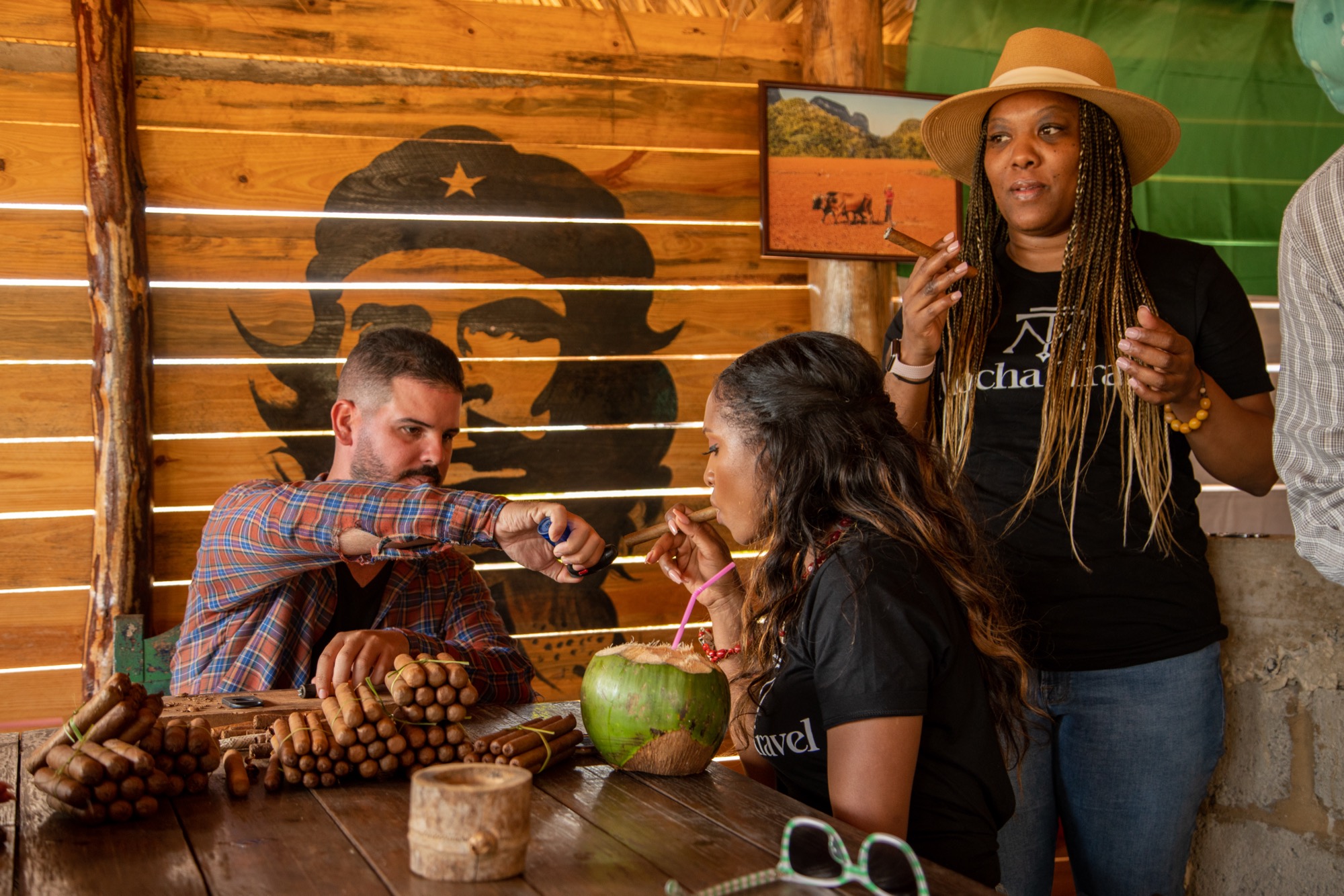 Guests at a Viñales tobacco farm tasting fresh cigars and coconut water