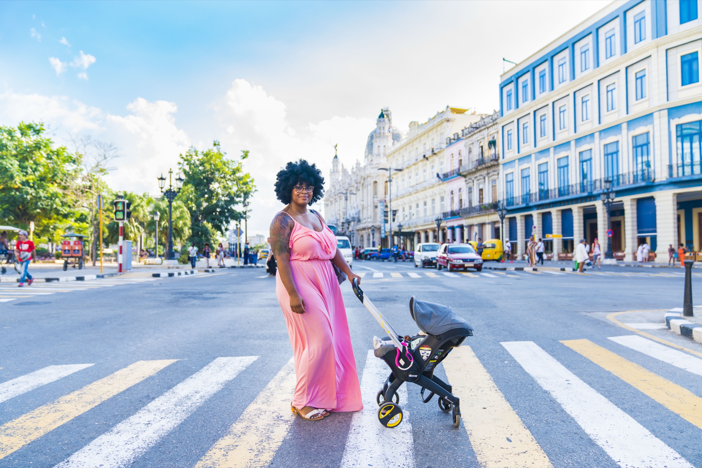 A woman crossing the street with a stroller