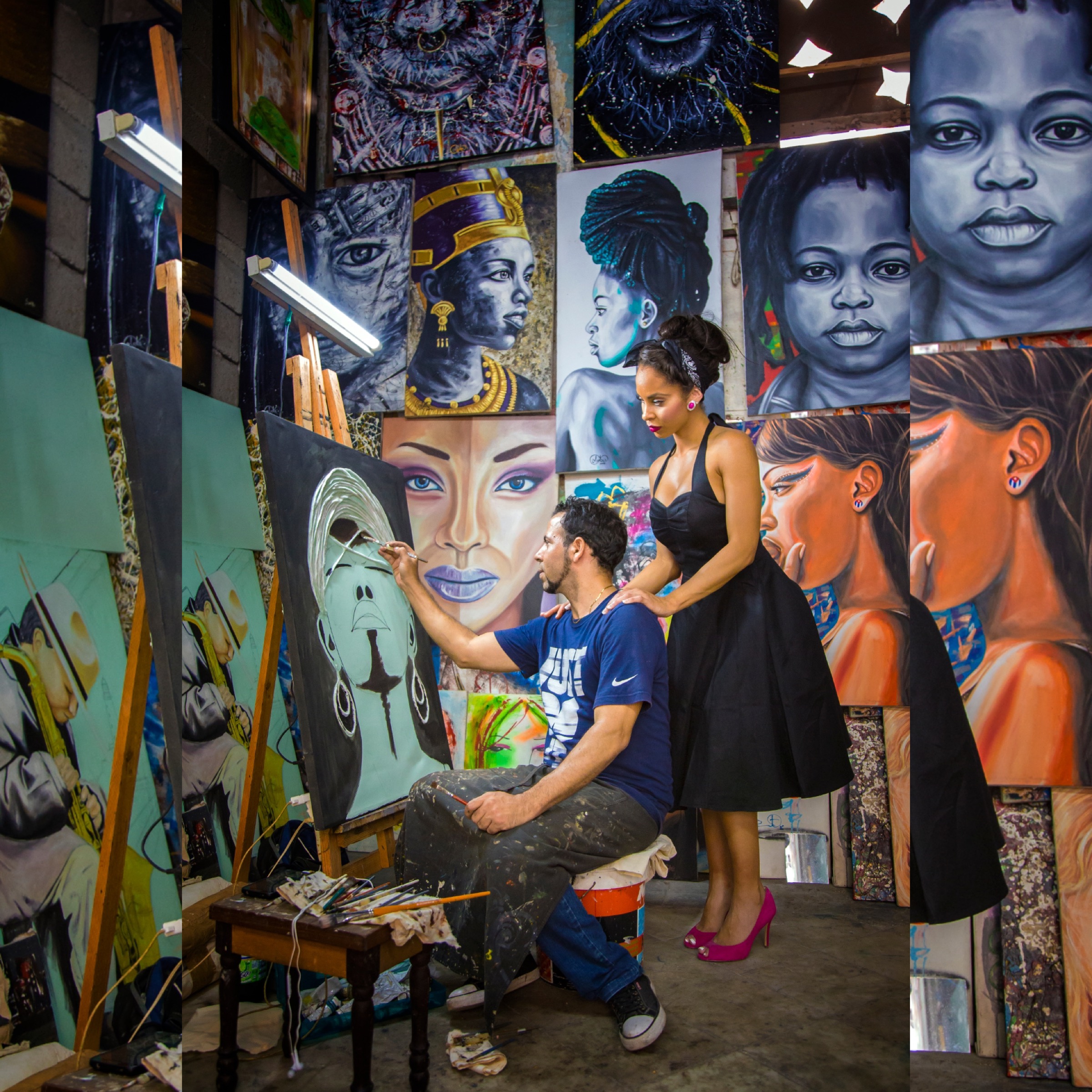 A visitor watching an artist paint inside a studio full of portraits
