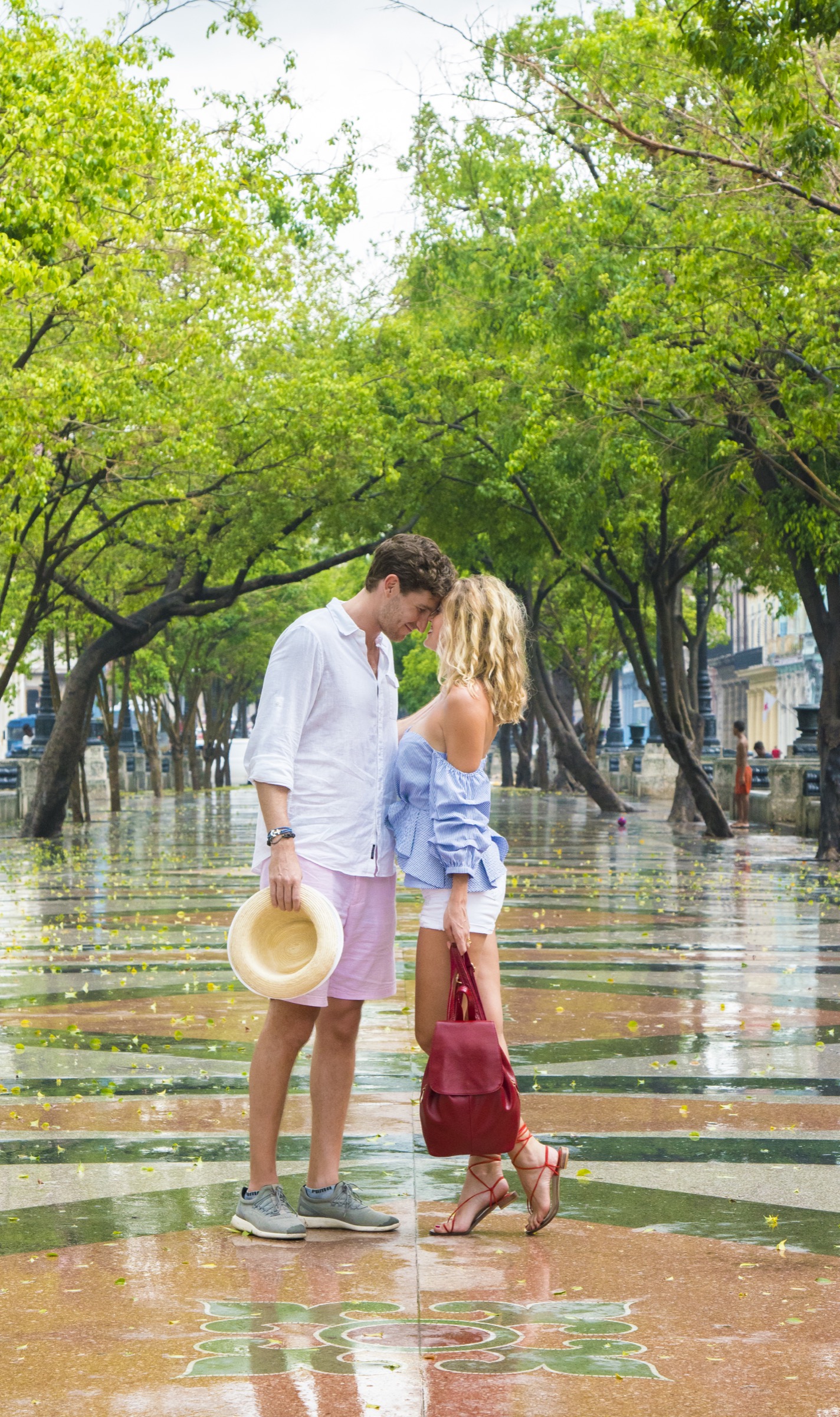 A couple together under the Prado's tree canopy