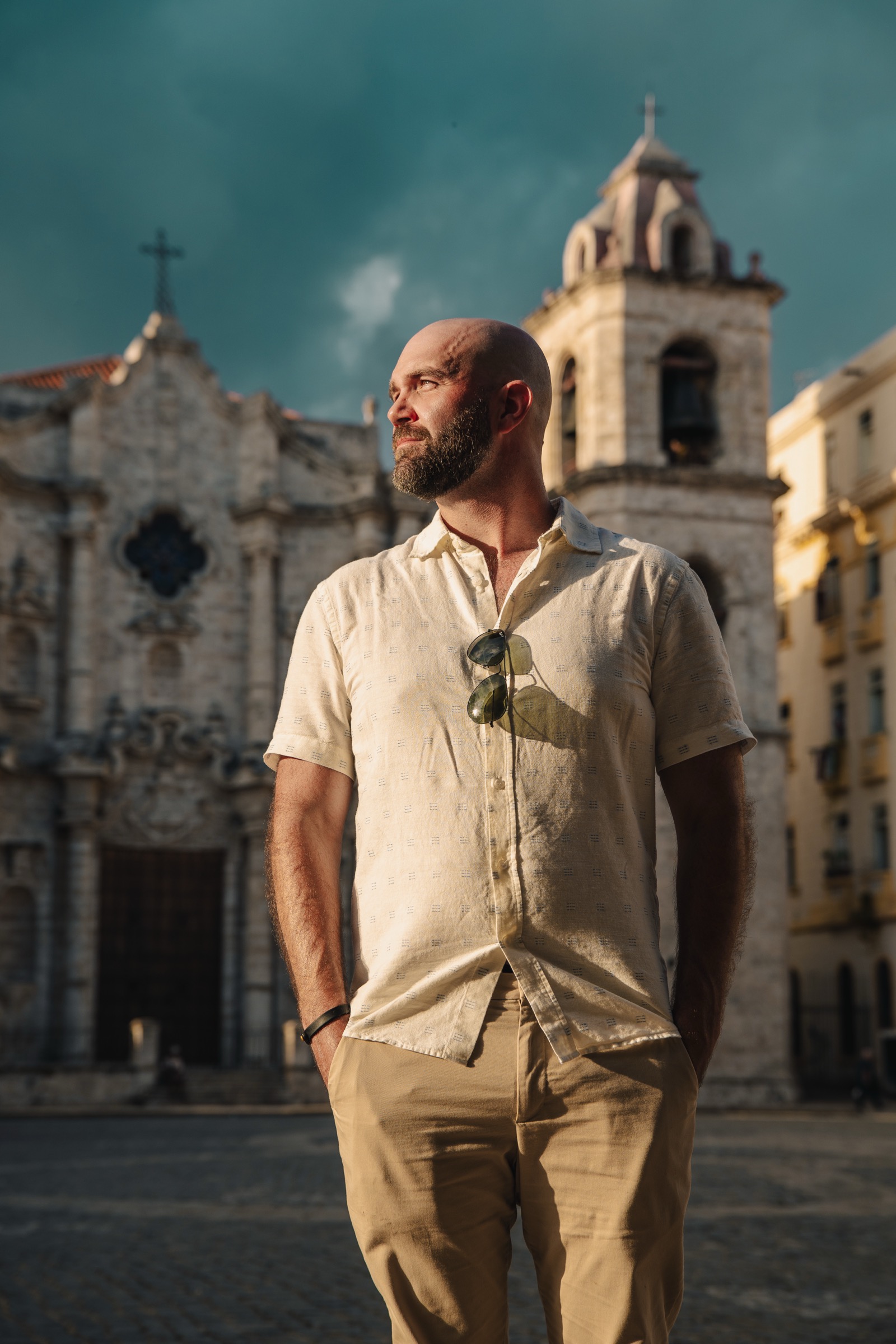 A man standing in the square under a moody, stormy sky